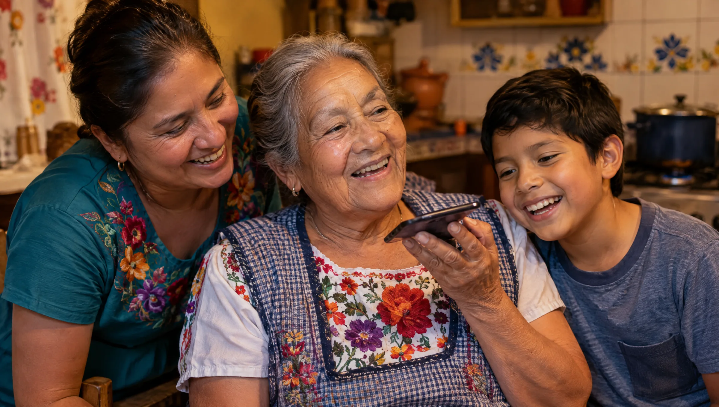 A grandmother, her daughter and grandson laughing together on a speaker call in their kitchen