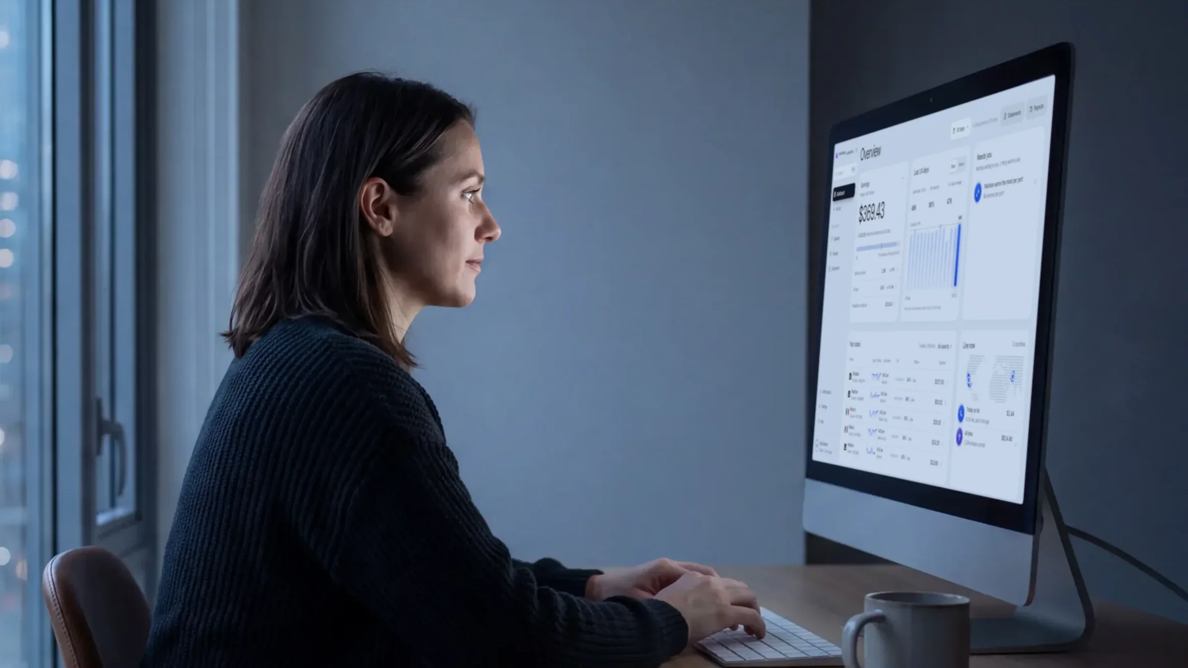 An owner at her desk reviewing the Accelerator dashboard on a large monitor